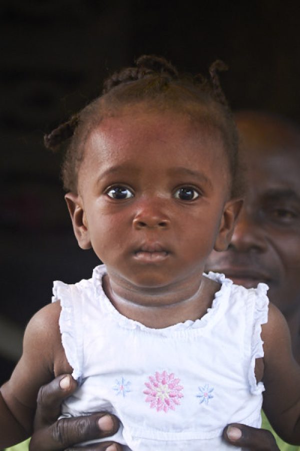 Shopkeeper with child in West Point – Monrovia, Liberia